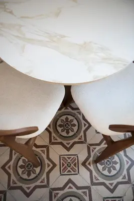 a white table and two chairs on a tile floor at Jensen Luxury Suites in Rhodes Town