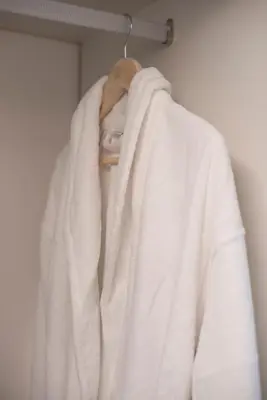 a white robe is hanging on a rack at Jensen Luxury Suites in Rhodes Town