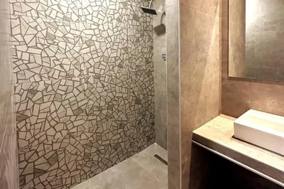 a bathroom with a shower with a sink and a mirror at Nirea studio in Faliraki Rhodes in Faliraki