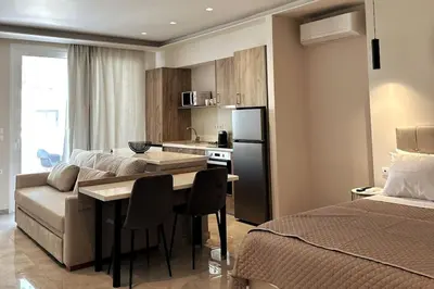 a kitchen and living room with a couch and a table at Nirea studio in Faliraki Rhodes in Faliraki