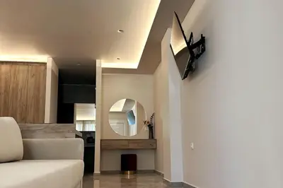 a living room with a couch and a mirror at Nirea studio in Faliraki Rhodes in Faliraki