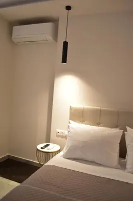 a bedroom with a white bed and a white ceiling at Nirea studio in Faliraki Rhodes in Faliraki