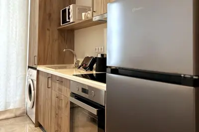 a kitchen with a stainless steel refrigerator and a sink at Nirea studio in Faliraki Rhodes in Faliraki