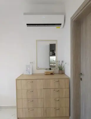 a mirror on top of a dresser in a room at Tina's Studio in Pastida