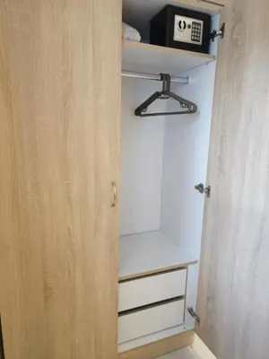 a closet with a wooden door and a shelf at Tina's Studio in Pastida