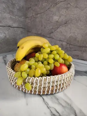 a basket of fruit sitting on a table at Tina's Studio in Pastida