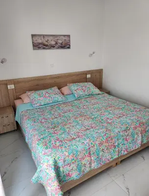 a bedroom with a bed with a colorful comforter at Gianna's Studio in Pastida