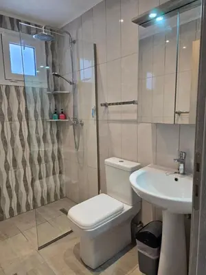 a bathroom with a toilet and a sink and a shower at Gianna's Studio in Pastida