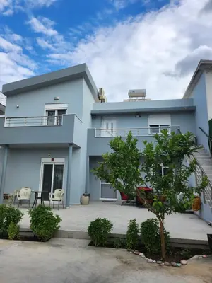 a blue house with a patio in front of it at Gianna's Studio in Pastida