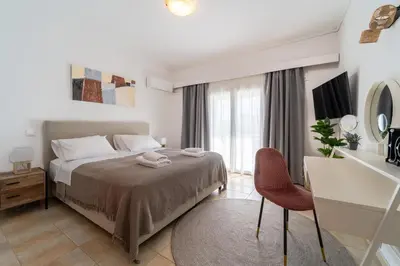 a bedroom with a bed and a table and a desk at Residence City Apartment in Rhodes Town