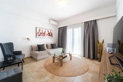 a living room with a couch and a table at Residence City Apartment in Rhodes Town