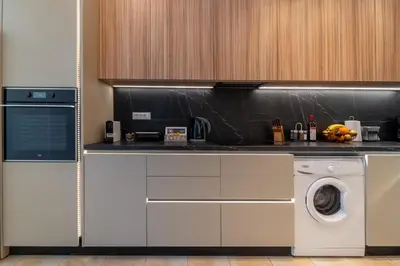 a kitchen with a washing machine and a washer at Residence City Apartment in Rhodes Town