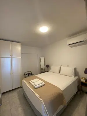 a bedroom with a bed with two towels on it at John's house in Rhodes Town