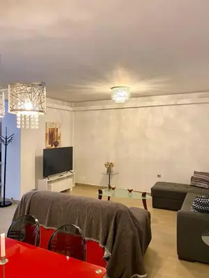 a living room with a couch and a tv at John's house in Rhodes Town