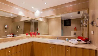 a bathroom with a sink and a large mirror at Private beach villa Princess in Kiotari