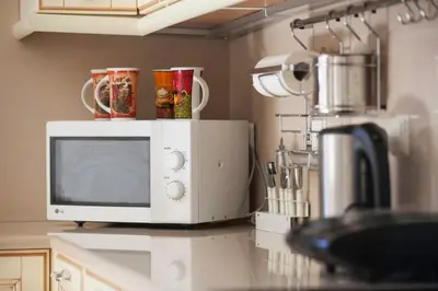 a microwave sitting on a counter in a kitchen at Private beach villa Princess in Kiotari