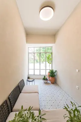 a living room with a couch and a window at Lemontrees Residences in Rhodes Town