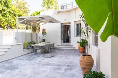 an outdoor patio with a table and chairs at Lemontrees Residences in Rhodes Town