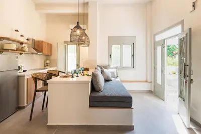 a kitchen with a couch sitting on a counter at Lemontrees Residences in Rhodes Town