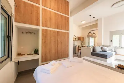 a bedroom with a bed and a living room at Lemontrees Residences in Rhodes Town