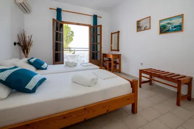 a bedroom with two beds and a window at George Seaside Serviced Studios & Apartments in Pefki Rhodes