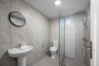 a bathroom with a sink and a toilet and a shower at Sokrates Apartments in Kolimbia
