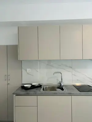 a kitchen with a sink and white cabinets at Chrisanthi Apartments in Archangelos
