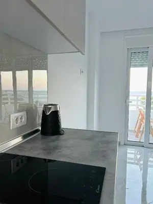 a kitchen with a counter top with a pot on it at Chrisanthi Apartments in Archangelos