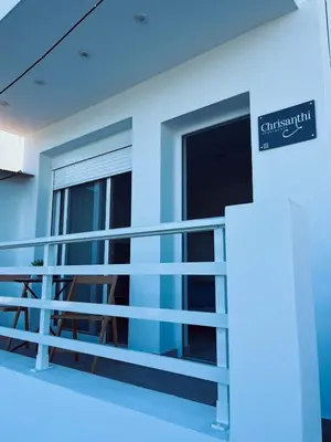 a balcony of a building with a sign on it at Chrisanthi Apartments in Archangelos