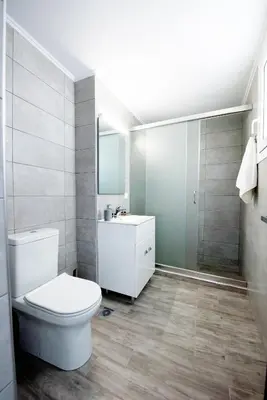 a bathroom with a toilet and a sink at Maria Studios & Apartments in Kremasti