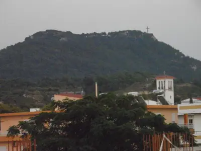 a mountain with a cross on top of it at Maria Studios & Apartments in Kremasti