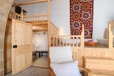 a room with a loft bed and a chair at Villa Nouna in Líndos