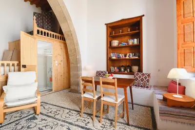 a living room with a table and chairs at Villa Nouna in Líndos