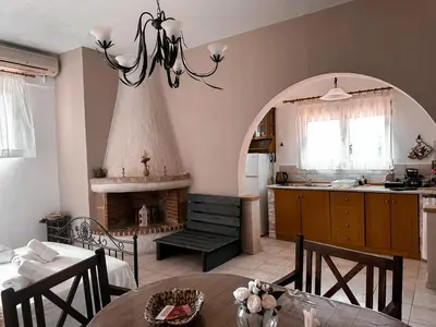 a kitchen with a table and a kitchen with a fireplace at Theonia Villas in Pefki Rhodes