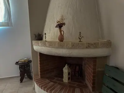 a brick fireplace with a vase on top of it at Theonia Villas in Pefki Rhodes