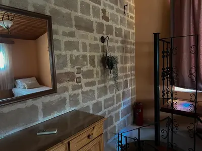 a bathroom with a brick wall and a mirror at Theonia Villas in Pefki Rhodes