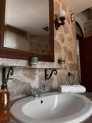 a sink in a bathroom with a mirror and a counter at Theonia Villas in Pefki Rhodes