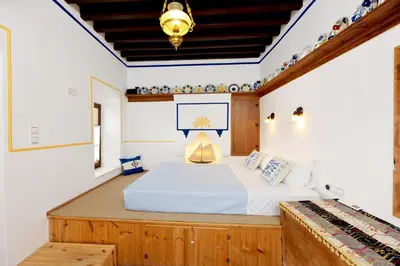 a bedroom with a large bed in a room at Villa Annoula - Traditional Lindian House in Líndos