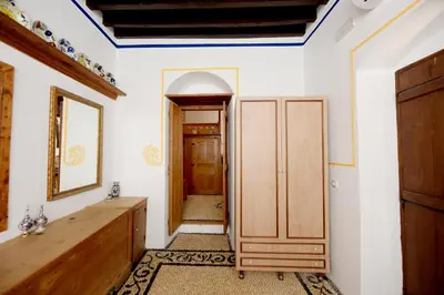 a room with a hallway with a mirror and a door at Villa Annoula - Traditional Lindian House in Líndos
