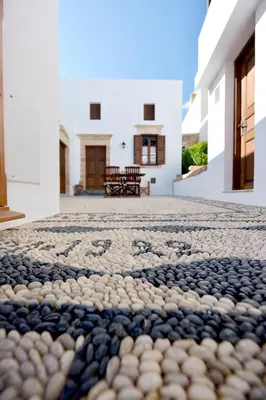 a stone floor in the courtyard of a house at Villa Annoula - Traditional Lindian House in Líndos