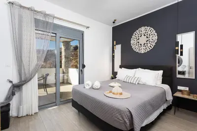 a bedroom with a bed with a hat on it at Villa Livis 1 in Kiotari