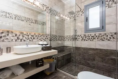 a bathroom with a sink and a shower at Villa Livis 1 in Kiotari