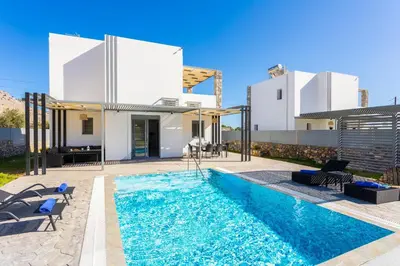 a swimming pool in the backyard of a house at Villa Livis 2 in Kiotari