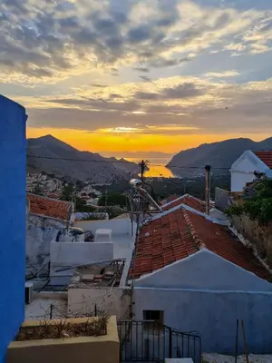 a view of the sunset from the roofs of buildings at Symi Uptown Indigo in Symi