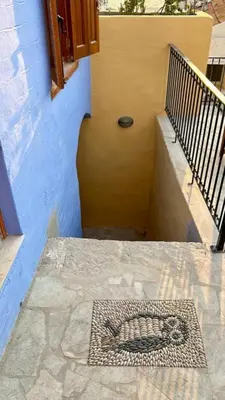a staircase with a mosaic of a dog on the floor at Symi Uptown Indigo in Symi