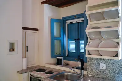 a kitchen with a sink and a blue cabinet at Symi Uptown Carmine in Symi