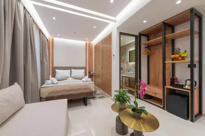 a bedroom with a bed and a table at The Wine Hotel in Rhodes Town