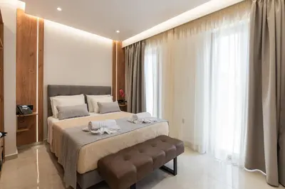 a bedroom with a large bed and a large window at The Wine Hotel in Rhodes Town