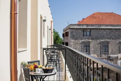 a balcony with a table with fruit on it at The Wine Hotel in Rhodes Town