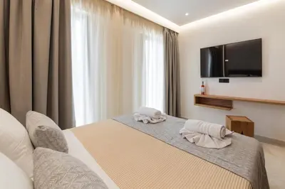 a hotel room with a bed with towels on it at The Wine Hotel in Rhodes Town
